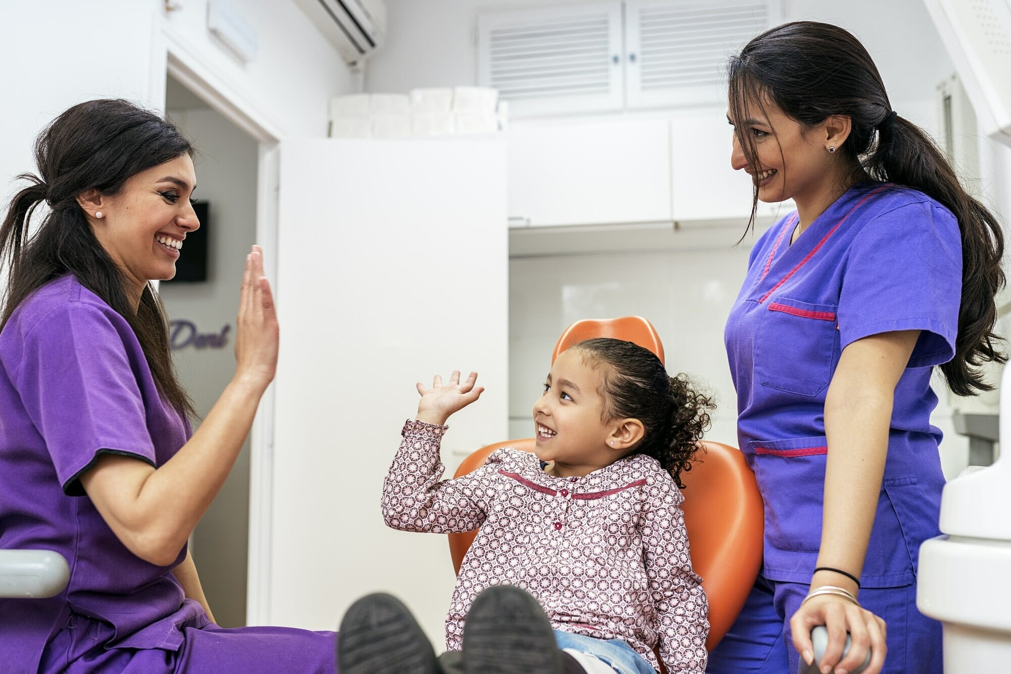 Cosmetic Dentist Marketing can bring new patients. Image shows Dentist doctor and child patient having fun